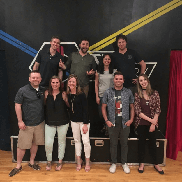 Escape Room Team Poses In Escape Artistry Lobby