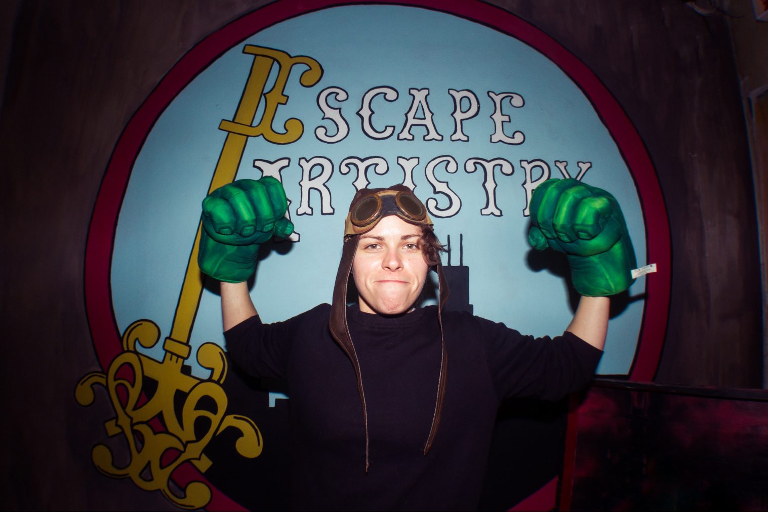 Woman Flexing Muscles With Hulk Gloves On