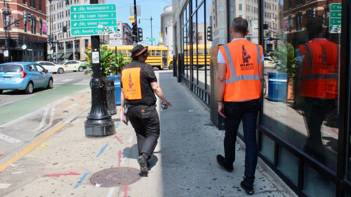 Two Wicker Park Ambassadors In Orange Vests Scout The Sidewalk