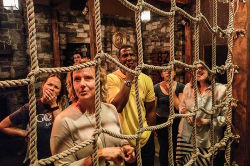 Group Of People Looking Curiously Through Rope Net